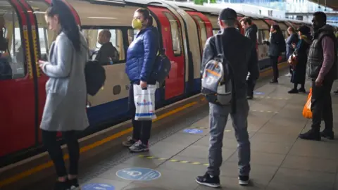 PA Media Passengers at Canning Town underground station in east London