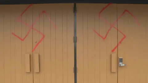 Andrew Foote/CBC Swastika signs on the front doors of Ottawa's Machzikei Hadas Synagogue