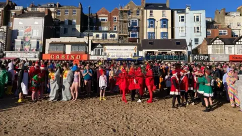 Carla Fowler/BBC The annual New Year's Day dip in Scarborough