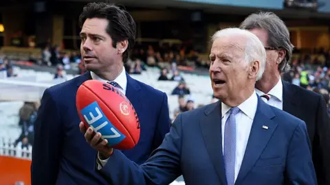 Getty Images AFL boss Gillon McLachlan (L) with former US Vice-President Joe Biden at a sports stadium in 2016