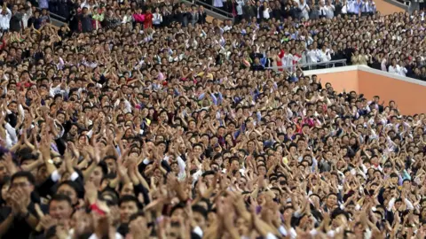 Getty Images North Koreans cheer for South Korean President Moon Jae-in and North Korean leader Kim Jong Un at the May Day Stadium on September 19, 2018 in Pyongyang