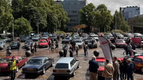 Paul Keating The image shows several examples of the Jaguar XJ40 and its variants in Coventry's University Squre as part of Motofest 2026.