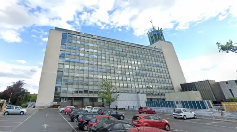 Google An exterior view of Newcastle Civic Centre, a large building with glass windows and an ornate tower on its right side.