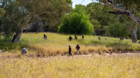 Volunteers join police and emergency services searching the scrubland surrounding Todd River on the third day of the search for missing 5-year-old girl.