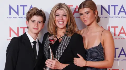 PA Media Kate Garraway with children Billy and Darcey