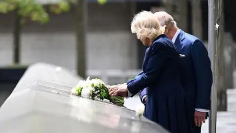 Getty Images The King and Queen laying a bouquet of flowers on the edge of one of the memorial’s pool during a ceremony at the National September 11 Memorial 
