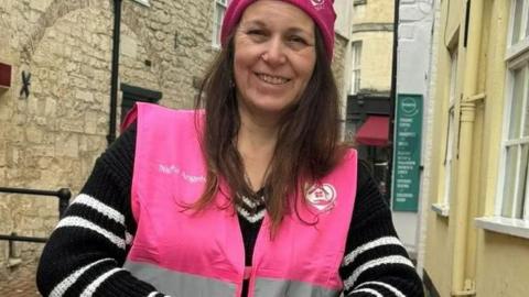 Chrissie Lowery smiling while wearing a pink hi vis vest