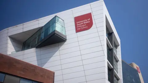 Exterior of University of South Wales building in Cardiff, white bloc face with three floors visible
