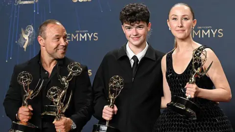 Getty Images Stephen Graham, Owen Cooper and Erin Doherty holding awards and smiling at the Emmys