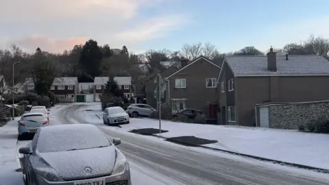 BBC An icy road in Tavistock showing white pavements and road surface.