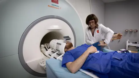 AFP via Getty Images A patient in an MRI machine