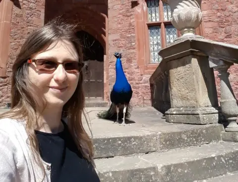 Sarah Johnson Sarah Johnson with a peacock