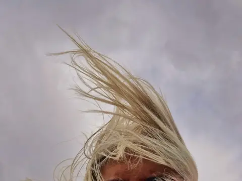 Juliet Davis Blonde hair being blown in the wind