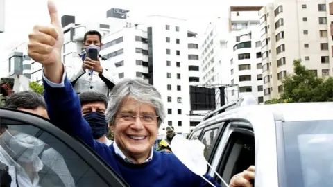 Reuters Guillermo Lasso waves to supporters as he leaves the Electoral National Council (CNE) in Quito, Ecuador, February 12, 2021.