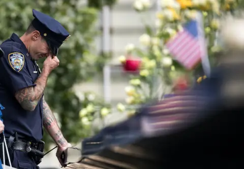 Getty Images Weeping police officer at 9/11 memorial