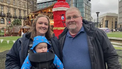 Victoria Scheer/BBC Gary Williams at Sheffield Christmas Market with his daughter and grandson
