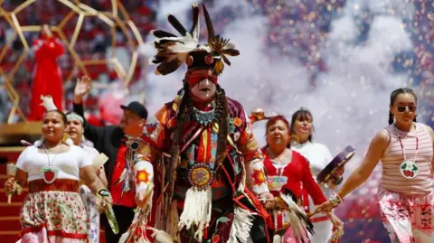 Reuters A native person in full regalia performs