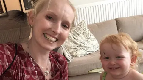 NHS Jo Daniels, who depends on male blood donors to keep her sight, posing with her daughter