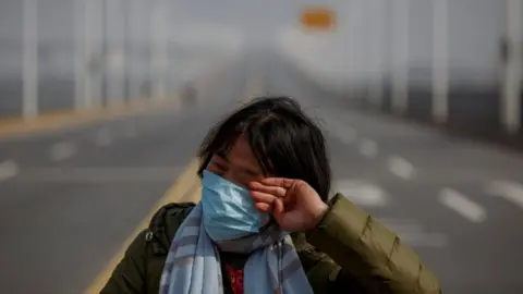 Thomas Peter - Reuters Lu Yuejin crying at the border