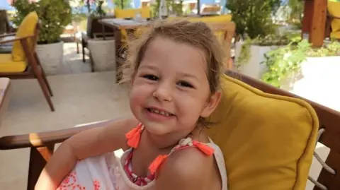 Sienna Dunion smiling while sat on a veranda