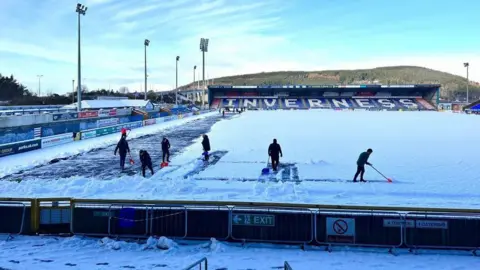 ICTFC Clearing snow from ICTFC pitch on Friday