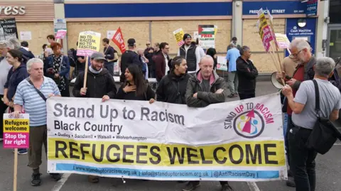 PA Media Counter protesters gather ahead of an anti-immigration protest in Birmingham