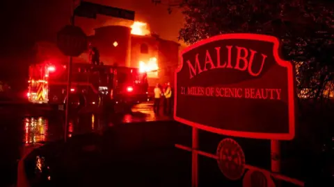 Firefighters battle winds and flames as multiple beachfront homes go up in flames along Pacific Coast Highway in Malibu