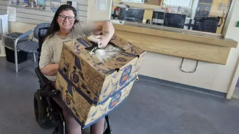 LDRS/Paula Clarke Paula Clarke holding two wholesale boxes of bananas.