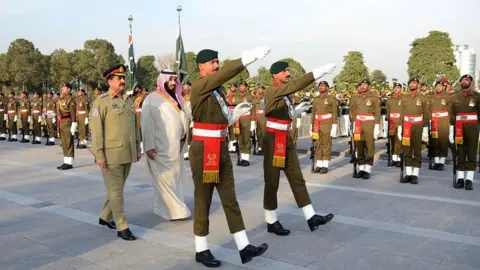 Getty Images Mohammad Bin Salman - then defence minister - is welcomed by Pakistani Army General Raheel Sharif on January 10, 2016