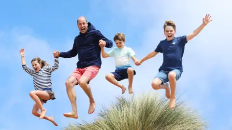 Princess of Wales/Kensington Palace/PA Prince William jumps in the air with his children