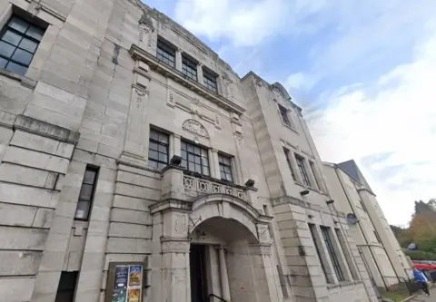 Google A picture of the front of a grand grey-coloured building