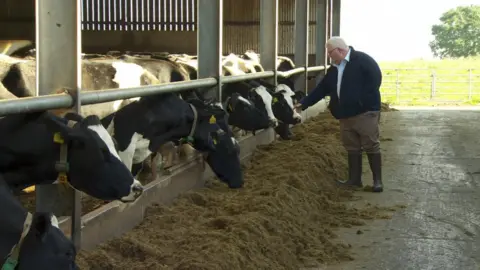 Charlie Weir inspects his cows