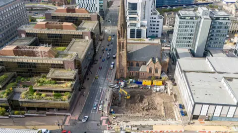 Artisan Real Estate The empty site with construction work beginning at the corner of St Vincent Street. It is next to St Columba Church of Scotland. 