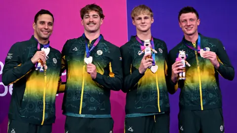 Getty Images Bronze medalists Pieter Coetze, Guy Brooks, Ruard van Renen and Chad le Clos of Team South Africa pose for a photo during the medal ceremony for the Men's 4 x 100m Freestyle Relay Final on day one of the Glasgow 2026 Commonwealth Games at Tollcross International Swimming Centre.