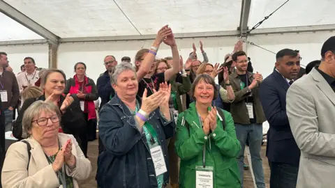 A group of people celebrate an election result