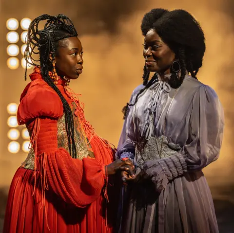 Johan Persson Elizabeth Ayodele (Princess Elia Martell) and Tanisha Spring (Ashara Dayne) in costume standing and speaking in a scene from Game of Thrones: The Mad King