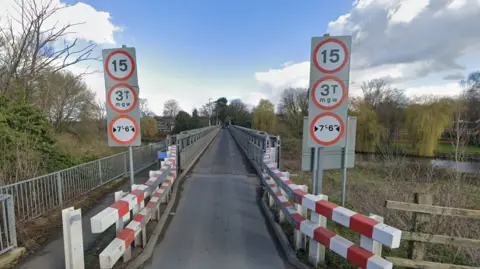 Google A Google Streetview image of Station Lane bridge showing it from end to end.