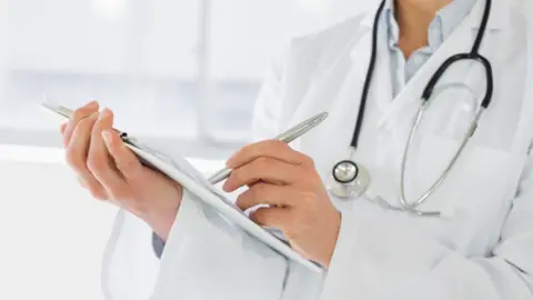 Thinkstock Doctor writing reports