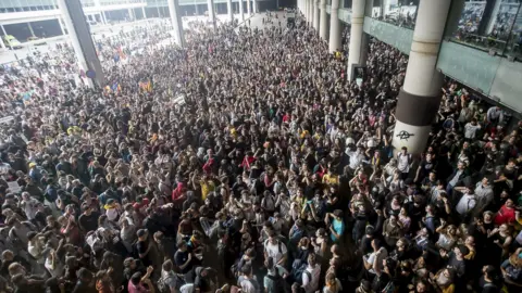 Getty Images Thousands of Catalonia pro-independence activists occupy Barcelona airport.