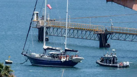 An Israeli patrol boat near the Madleen yacht as it moored at the port of Ashdod in Israel on 10 June.