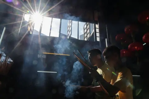 Hasnoor Hussain/Reuters Worshippers pray at the Taoist temple of Sin Sze Si Ya in Kuala Lumpur
