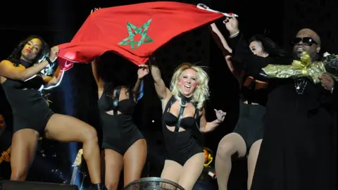 AFP US singer Ceelo Green and dancers hold up the Moroccan flag during Mawazine festival in 2013.