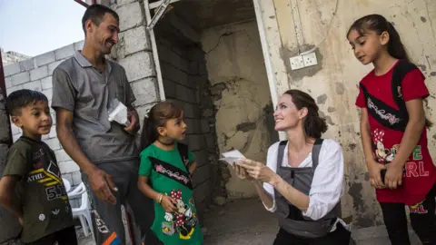 UNHCR/Andrew McConnell Angelina Jolie and an Iraqi family