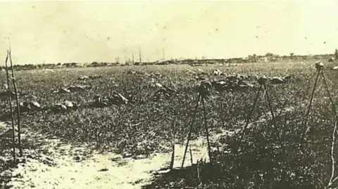 An image from the First World War of dead men on a battlefield. 