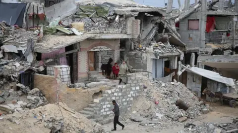 Reuters Palestinians gathered in a ruined building in Gaza