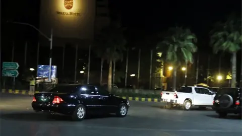 EPA A car is photographed arriving at a hotel in Islamabad