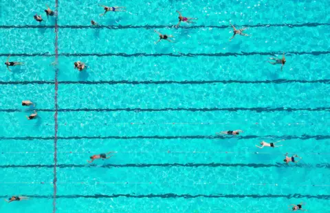 PA People swimming in lanes in a pool