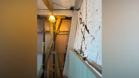 Handout The interior of a building with damaged walls.