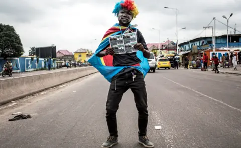 AFP A supporter of Felix Tshisekedi holds a picture in Kinshasa, DR Congo - Thursday 10 January 2019