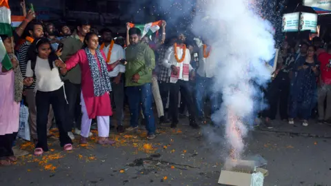 ANI Protesters in Ranchi city gathered around a firecracker as they wave flags and cheer